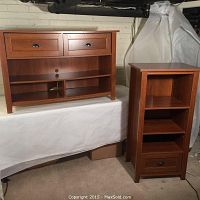 Two entertainment stands together showing the size and style differences.