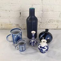 Wide view of entire lot showing six pottery items including mug, bottle-shaped vase, and various smaller vases.