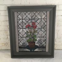 Front view of the oil on canvas painting with grey wooden frame against a white brick wall