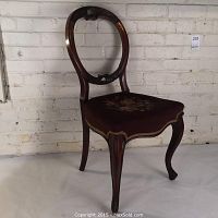 Full side view showing curved legs, needlepoint seat and balloon backrest