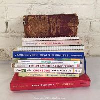 Stack of 12 assorted cookbooks including vintage Mrs. Beeton's Book of Household Management and modern titles