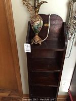 Wooden shelf with five shelves and the decorative lamp sitting on top, showing overall size and condition