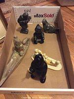Five soapstone carvings arranged in box showing lot composition