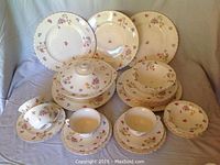 Full view of the 29-piece Myott Staffordshire china set including plates, cups, saucers, and covered bowl arranged on a cloth.