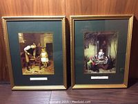 Two framed art prints side by side on a wood panel background, each with green mats and gold-tone frames.
