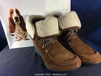 Front and top side view of Hush Puppies women's booties showing brown suede upper and cream sherpa fold-over cuff with laces and wedge sole.