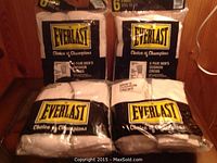 Four packages of Everlast men's cushion crew socks, white with white stripes, 6 pairs per pack.