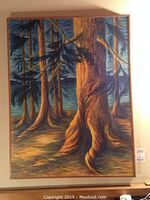 Full view of the framed oil painting showing large tree trunks in a forest setting with textured brushwork and vibrant colors