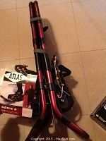 Folded red and black Atlas snowshoes with original tag