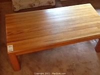 Full view of rectangular oak coffee table with natural wood grain visible on tabletop.
