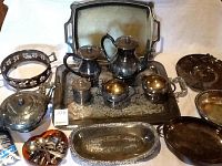 Full view of the tea service and trays including coffee pot, tea pot, cream, sugar, trays, and additional serving pieces.