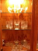 Top shelf with wine or sherry glasses and punch bowl