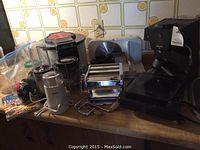 Overall view of lot showing meat slicer, Tefal deep fryer, Magic Bullet blender cups and pasta maker on kitchen counter