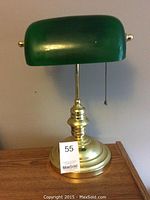 Photo of a 15" tall banker’s desk lamp with a green glass shade and brass base, featuring a pull chain switch.