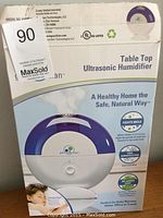 Photo of the Germ Guardian ultrasonic humidifier box showing product image and key features including silver clean technology, cool mist humidification, and quiet operation.