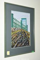 Framed and matted watercolour painting showing green fence, stone wall and white house.