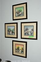 Photo of four framed watercolor paintings mounted on wall, arranged in square shape showing various bridge scenes.