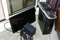 HP desktop tower, speakers and monitor shown side by side