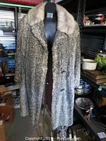 Front view of the grey sheepskin coat with mink collar on a mannequin.