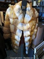 Front view of red fox fur coat on mannequin
