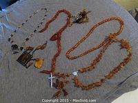 Multiple necklaces, pendants, and earrings laid flat
