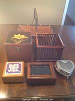 All six items in the lot displayed: wicker basket, four wooden boxes including music box, and heart-shaped metallic box