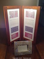 Wooden multi-photo frame and stone single 4x6 photo frame placed on a wooden surface.