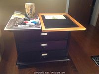 Wooden organizer with three drawers, chalkboard, pencil holder, and small supplies displayed on wooden table.