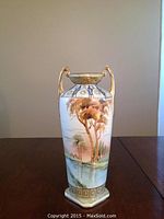 Side view of the vase showing hand-painted landscape and gold handles