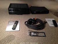 Yamaha RX-V620 AV receiver and Toshiba SD-3750 DVD player with remotes and bundled cables spread out on carpet.