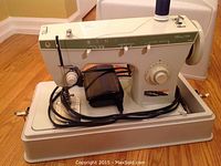 Front and side view of the Singer Fashion Mate 252 sewing machine showing needle position and pattern selector controls, foot pedal, and spool of thread.