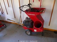 Overall side view showing feed hopper, engine, discharge chute and wheels