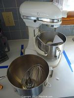 Mixer in white with one bowl attached and second bowl on countertop