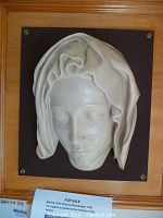 Framed plaster bust of Virgin Mary, front view, showing detailed facial features and veil folds.