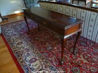 Front-left perspective showing full tabletop, drawer face and leg profile