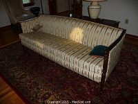 Front view of striped floral upholstered sofa on patterned rug
