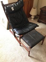 Full view of wooden frame chair with matching ottoman
