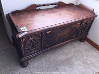 Full front and top view of the wooden chest showing overall condition and carving detail.