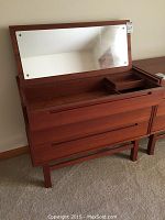 Overall view of vanity with top flipped open showing mirror and interior trays.