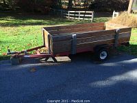 Full side view showing metal frame, wooden side panels and ball hitch