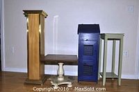 Four wooden furniture pieces together showing their relative size and style: wooden pedestal, square lamp table, blue storage unit, and green stand.