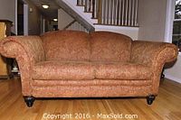Full front view of Rowe upholstered loveseat sofa showing rolled arms, patterned fabric, and overall shape.