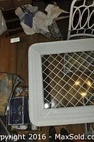 Top view of white wicker rectangular table showing clear tempered glass top with woven wicker frame underneath.