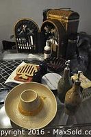 Photo showing the open picnic basket with utensil compartments and multiple decorative serveware items surrounding it.