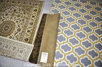 Three rugs side by side: off-white and red Persian, beige rug, modern yellow-gray-white geometric rug
