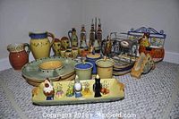 Full lot image showing multiple Pfaltzgraff Pistoulet ceramic serving pieces including pitchers, condiment containers, oil and vinegar dispensers, deviled eggs platter with ceramic chicken and vegetable holders, and metal condiment rack.