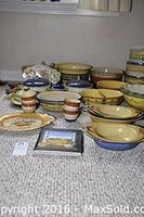 Overview of over 25 items including bowls, platters, and dishes in yellow, cream, green, blue, and terracotta tones of Pistoulet design