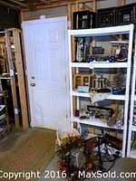 Overview of the shelf unit holding various black shadow boxes and other decorative items