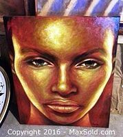 Close-up photo of Golden Gils painting depicting a woman's face with golden tones.