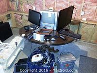 Full view of table with Samsung and Sharp TVs, Toshiba DVD player, shredder, keyboard, remotes, and other accessories.